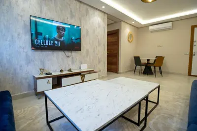 a living room with a tv on a wall at Stylish Apartment Heart of Gueliz Netflix in Marrakech