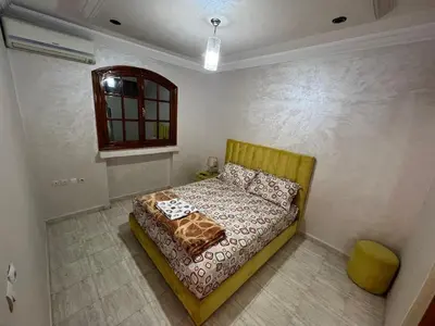 a bedroom with a bed and a window at Villa Ground Floor Rent Apt in Marrakech