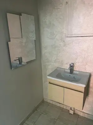a bathroom with a sink and a mirror at Villa Ground Floor Rent Apt in Marrakech