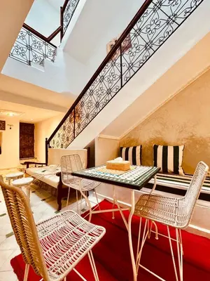a dining room with a table and chairs at Riad Kimee Room 4 in Marrakech