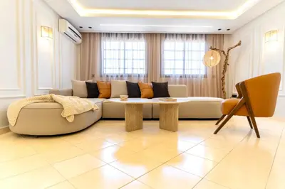 a living room with a couch and a table at Appartement élégant avec jacuzzi à deux pas de Guéliz in Marrakech