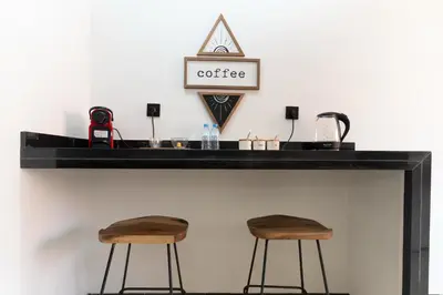 a counter with two stools at a coffee bar at Appartement élégant avec jacuzzi à deux pas de Guéliz in Marrakech