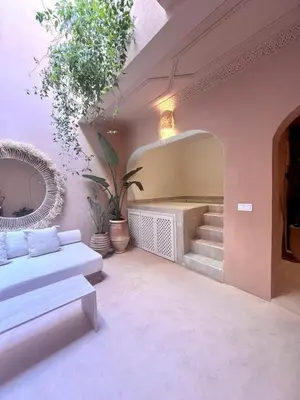 a living room with a couch and a staircase at Riad Roseli in Marrakech