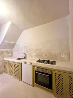 a kitchen with a sink and a stove at Riad Roseli in Marrakech