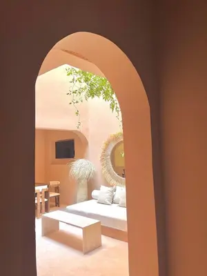 a living room with a white couch and a table at Riad Roseli in Marrakech