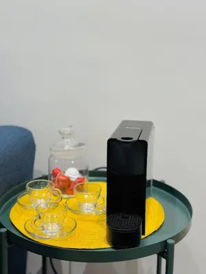 a black laptop sitting on a glass table with glasses at Gueliz Gem Chic, Comfy & Central in Marrakech