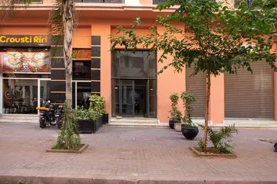 a building with a motorcycle parked in front of it at Gueliz Gem Chic, Comfy & Central in Marrakech