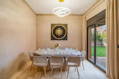 a dining room with a table and chairs at Villa Palmera - 6 people - Pool - Marrakech in Marrakech