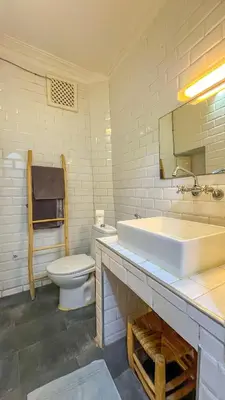 a bathroom with a white sink and a toilet at Ma petite maison cosy en medina in Marrakech
