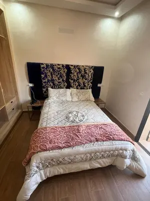 a bedroom with a large bed with a black headboard at Villa Marrakech in Marrakech