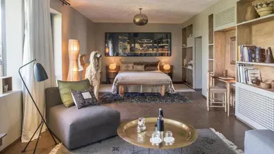 a living room with a bed and a couch and a table at Dar-el-adaka in Marrakech
