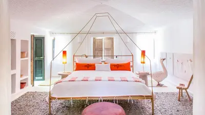 a bedroom with a large bed with orange pillows at Dar-el-adaka in Marrakech