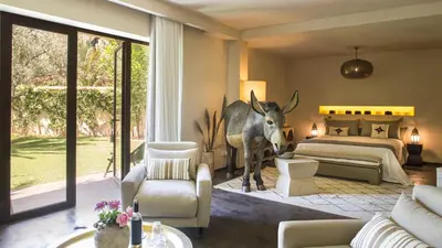 a room with a bedroom with a statue of a deer in it at Dar-el-adaka in Marrakech