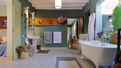 a large bathroom with a tub and a sink at Dar-el-adaka in Marrakech