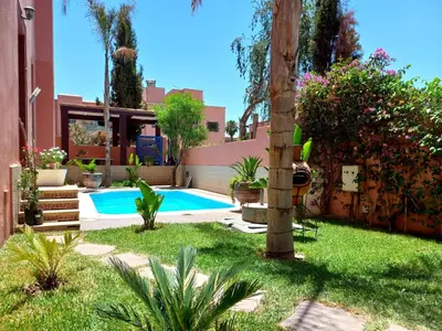 a swimming pool in a yard with plants at CYCAS VILLA TARGA GARDEN -Only Family in Marrakech