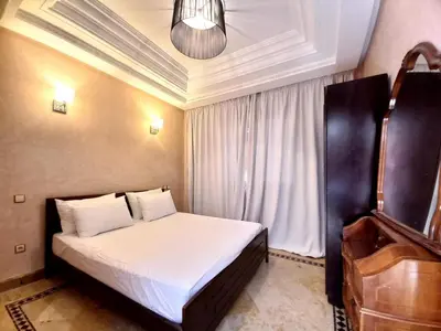 a small bedroom with a bed and a piano at CYCAS VILLA TARGA GARDEN -Only Family in Marrakech