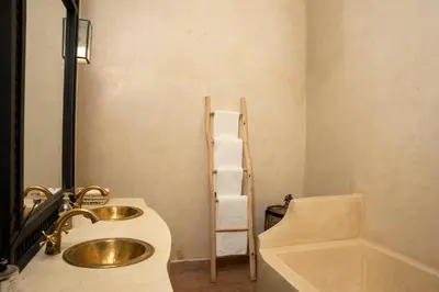 a bathroom with a sink and a toilet and a ladder at Villa Sidi Oasis in Marrakech