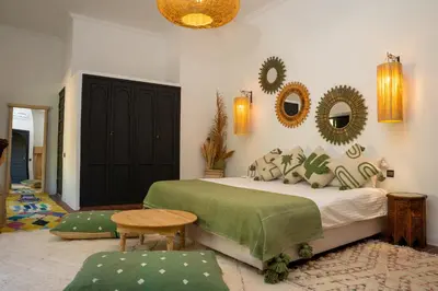 a bedroom with a bed and mirrors on the wall at Villa Sidi Oasis in Marrakech