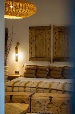 a bedroom with a large bed with wooden cabinets at Villa Sidi Oasis in Marrakech