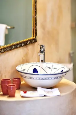 a sink in a bathroom with a mirror at RIAD Zina Rose 89 in Marrakech