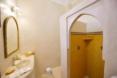 a bathroom with a sink and a shower with a mirror at RIAD Zina Rose 89 in Marrakech