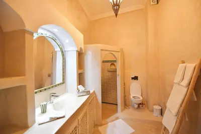 a bathroom with a sink and a toilet and a mirror at RIAD Zina Rose 89 in Marrakech