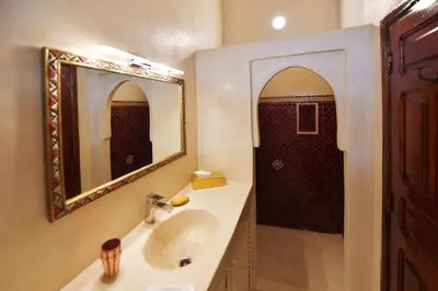 a bathroom with a sink and a mirror and a shower at RIAD Zina Rose 89 in Marrakech
