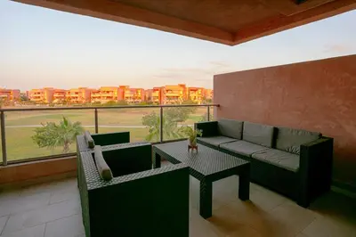 a living room with a couch and a table at The Garden Course - Marrakech - Prestigia in Marrakech