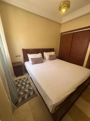 a bedroom with a large white bed with two pillows at Sofia Palmeraie Appartement in Marrakech