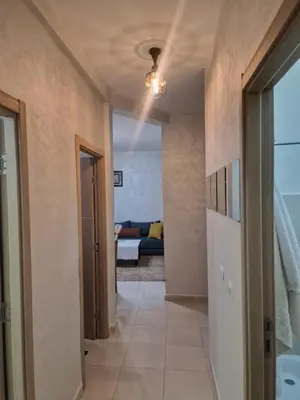 a hallway leading to a room with a bed at appartement mabrouka in Marrakech
