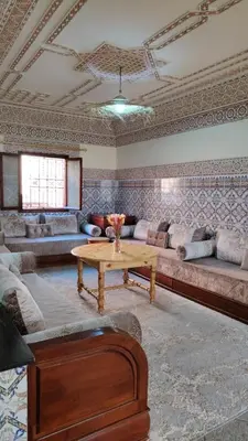 a living room with a couch and a coffee table at Maison traditionnelle marocaine à Marrakech in Marrakech