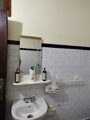 a small bathroom with a sink and a mirror at Maison traditionnelle marocaine à Marrakech in Marrakech