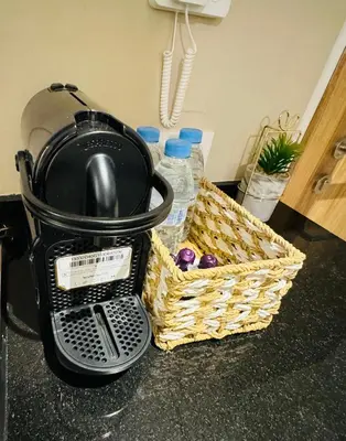 a pot and a basket on a counter with water bottles at Noria Golf Marrakech in Marrakech