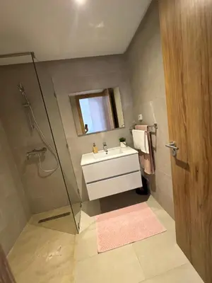 a bathroom with a sink and a shower with a mirror at Noria Golf Marrakech in Marrakech