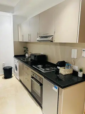 a kitchen with a stove and a microwave at Noria Golf Marrakech in Marrakech