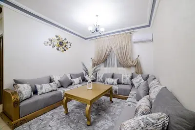 a living room with a couch and a table at Charming and quiet apartment 2 in Marrakech