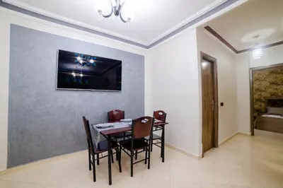 a dining room with a table and chairs at Charming and quiet apartment 2 in Marrakech