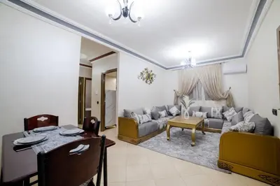 a living room with a couch and a table at Charming and quiet apartment 2 in Marrakech