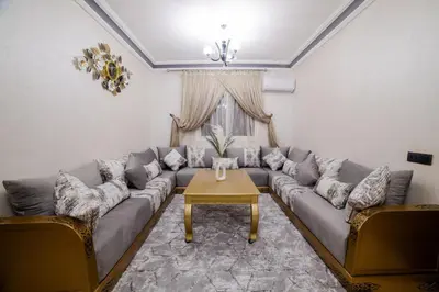 a living room with a couch and a table at Charming and quiet apartment 2 in Marrakech
