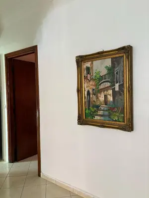 a painting hanging on a wall next to a door at Appartement cosy in Marrakech