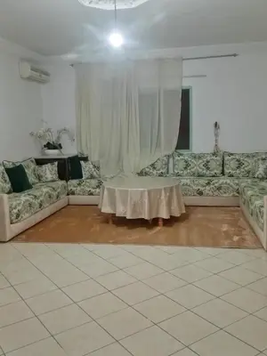 a living room with a couch and a table at Appartement cosy in Marrakech