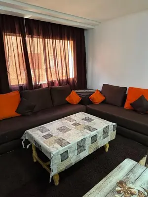 a living room with a couch and a coffee table at le KABANA 37 face gare CTM Hivernage in Marrakech