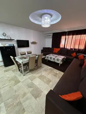 a living room with a couch and a table at le KABANA 37 face gare CTM Hivernage in Marrakech