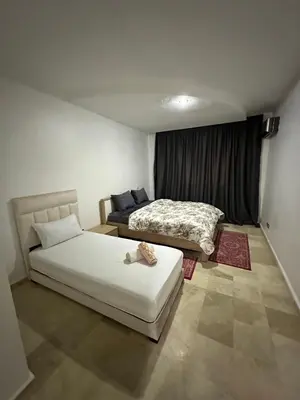 a bedroom with two beds and a window at le KABANA 37 face gare CTM Hivernage in Marrakech