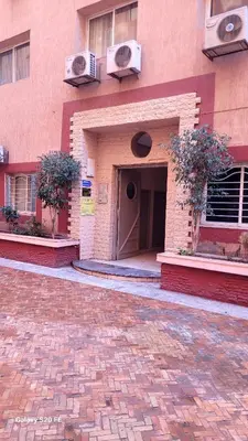 a brick building with a door on the side of it at le KABANA 37 face gare CTM Hivernage in Marrakech