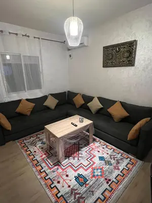 a living room with a couch and a coffee table at Marrakesh cozy apartment 15mn city center in Marrakech
