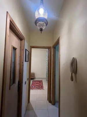 a hallway with a chandelier and a hallway with at Marrakesh cozy apartment 15mn city center in Marrakech