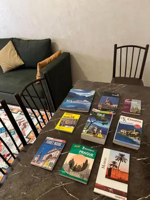 a table with a bunch of books on it at Marrakesh cozy apartment 15mn city center in Marrakech