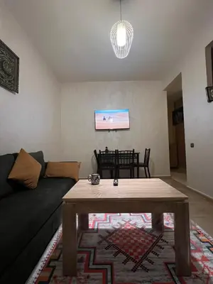 a living room with a couch and a table at Marrakesh cozy apartment 15mn city center in Marrakech