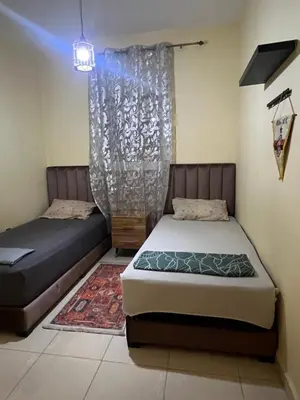 a bedroom with two beds and a curtain at Marrakesh cozy apartment 15mn city center in Marrakech